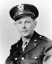 A young-looking man in military uniform with crosses on his lapels