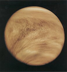 The atmosphere of Venus appears darker and lined with shadows. The shadows trace the prevailing wind direction.