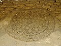 Detail of a carved stucco roundel on the southwestern façade