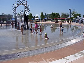 Fountains in Warren City Center, with farmer's market in background