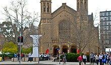 This is a photograph of students from the two neighbouring universities near Bonython Hall on North Terrace.