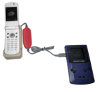 Game Boy Color connected to a cell phone via an adapter