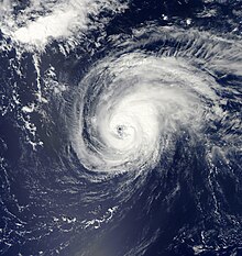 A satellite image of a well-defined hurricane over the open Atlantic Ocean