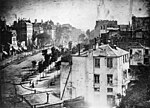 "View of the Boulevard du Temple" (1838) av Louis Jacques Mandé Daguerre, det första fotografiet med en person på motivet.