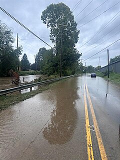 A flooded street near a swollen river in Buncombe County, North Carolina, on 27 September 2024.