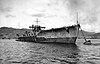 A large gray ship sits at rest; the area above the main deck is almost entirely incomplete