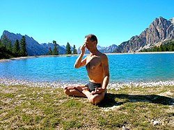 Pratique du prāṇāyāma. Ici, exécution de nadi shodhana, un exercice pratiqué en padmāsana qui alterne souffle et rétention du souffle.