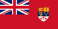 Red flag with Union Flag as top-left quarter and crest on right side.