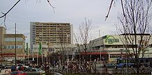 Olumpia shopping mall from afar, street view, on partly cloudy winter day