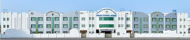 White, rectangular building with many windows