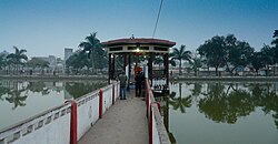 Nepalgunj skyline, with Bageshawri pond and statue of Mahadev in the foreground and New Road houses in the background.