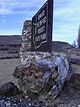 Petrified wood below park signage