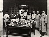 Doat (at far right), Frederick Hurten Rhead (far left), and others at the Art Academy of People's University (now the Lewis Center) in University City, Missouri, celebrating its first high-firing kiln in April 1910