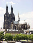 A large gothic style cathedral of grey to black colored stone.