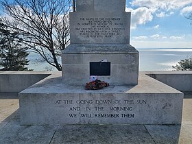 Different shaped stone blocks bearing black lettering and a bronze plaque