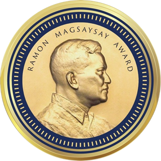 Medallion with an embossed image of Ramon Magsaysayl facing right in profile.