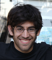 Swartz with glasses, smiling with Jason Scott (cut off from the picture from the left)