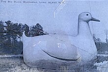 A pictorial drawing of the Big Duck in what appears to be a rural location; trees and telegraph poles are visible in the background.