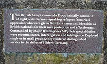 Slate memorial on stone wall