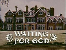 Front view of large English manor home with large lawn, with text "Waiting for God" superimposed