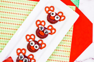 Aerial shot of Reindeer Donuts on a long white plate, sitting on top of Christmas-themed place mats