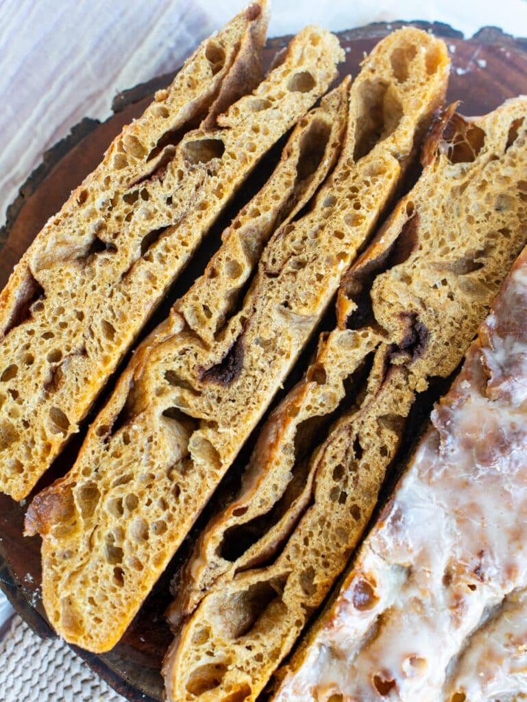 Three slices of sourdough gingerbread focaccia sliced open on a board.