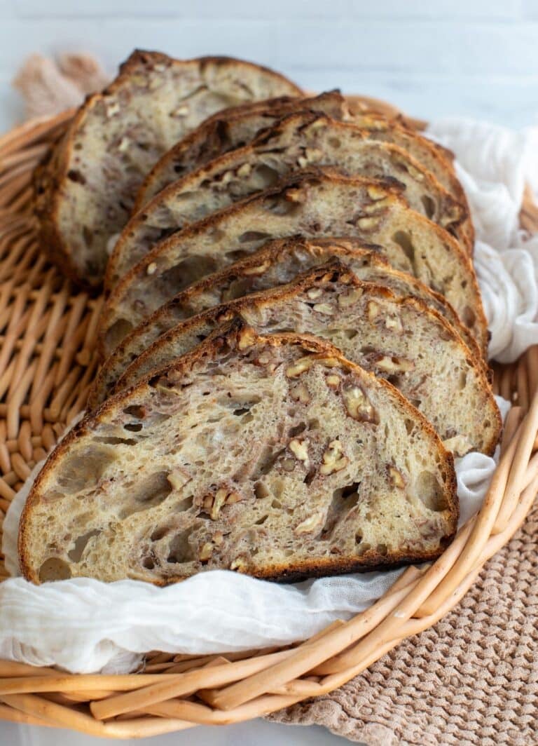 Slices of maple pecan sourdough bread in a basket.