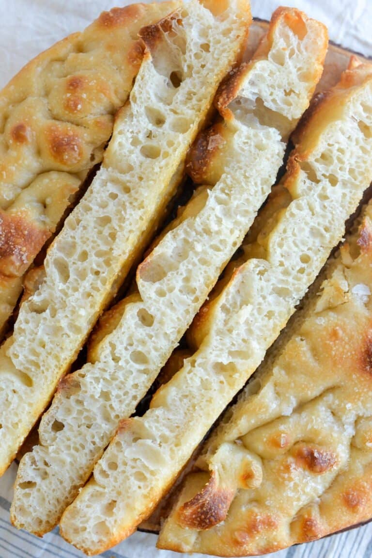 Slices of sourdough mashed potato focaccia cut open and turned to see the airy crumb.