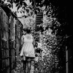 Mother and kids walking backstreet together