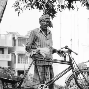 Man standing by cycle rickshaw