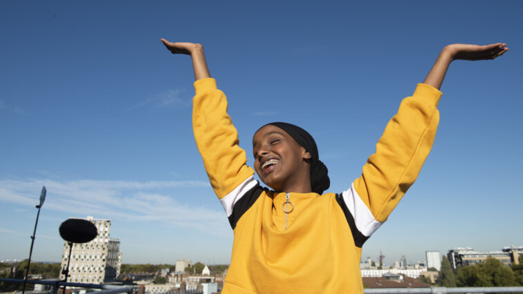 Girl raising her arms