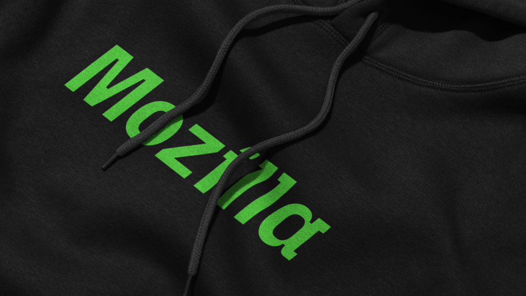 A close-up of a black hoodie with "Mozilla" printed in vibrant green, showcasing a modern and bold typeface.