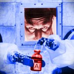 A modified photo of a 1956 scientist carefully bottling "AI" with robotic arms from behind a protective wall.