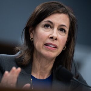 FCC Chairwoman Jessica Rosenworcel sits in front of a microphone while testifying during a Congressional hearing.