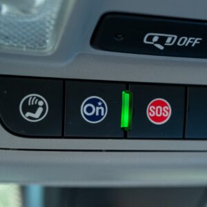 Buttons in a car labeled "On" and "SOS."