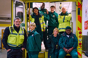 Bloods. Image shows from L to R: Lawrence (Julian Barratt), Jo (Lucy Punch), Kareshma (Aasiya Shah), Darryl (Kevin Garry), Darrell (Sam Campbell), Wendy (Jane Horrocks), Gary (Adrian Scarborough), Maleek (Samson Kayo)