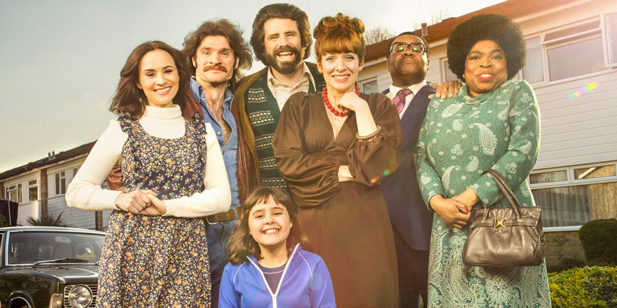 The Kennedys. Image shows from L to R: Jenny (Emma Pierson), Tim (Harry Peacock), Emma Kennedy (Lucy Hutchinson), Tony Kennedy (Dan Skinner), Brenda Kennedy (Katherine Parkinson), David Palmer (Clive Rowe), Dee Palmer (Shola Adewusi). Copyright: BBC