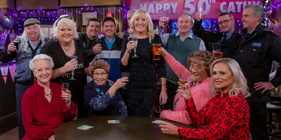 Mrs. Brown's Boys. Image shows from L to R: Grandad Brown (Dermot O'Neill), Hillary Nicholson (Susie Blake), Sharon McGoogan (Fiona Gibney), Dermot Brown (Paddy Houlihan), Winnie McGoogan (Eilish O'Carroll), Buster Brady (Danny O'Carroll), Cathy Brown (Jennifer Gibney), Dr Flynn (Derek Reddin), Agnes Brown (Brendan O'Carroll), Betty Brown (Amanda Woods), Garda Ferguson (Stephen McConnell), Garda Sheridan (Mark Sheridan). Copyright: BBC