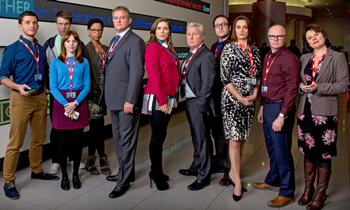 W1A. Image shows from L to R: Jack Patterson (Jonathan Bailey), Will Humphries (Hugh Skinner), Izzy Gould (Ophelia Lovibond), Lucy Freeman (Nina Sosanya), Ian Fletcher (Hugh Bonneville), Siobhan Sharpe (Jessica Hynes), Neil Reid (David Westhead), David Wilkes (Rufus Jones), Anna Rampton (Sarah Parish), Simon Harwood (Jason Watkins), Tracey Pritchard (Monica Dolan). Copyright: BBC