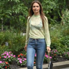 Katie Holmes walks in New York City wearing a sheer top with an exposed bra and skinny jeans