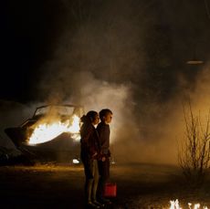 Young girl and boy watching fire