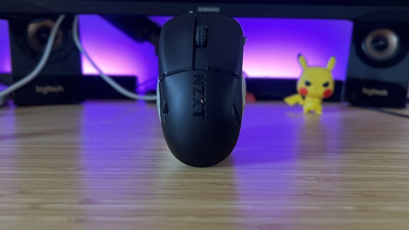 NZXT Lift Elite Wireless gaming mouse on a standing upright on a wooden gaming desk with purple lighting