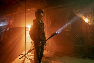 a still of Song Kang-ho, holding an electric spear with a flashlight at the end, in 'Sweet Home'