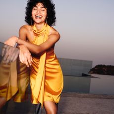 a woman wearing a light orange dress