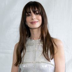 Anne Hathaway with bangs and closed-mouth smile