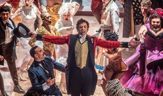 Hugh Jackman wears a circus hat and velvet red jacket in the movie 'The Greatest Showman'