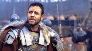 Russell Crowe as Maximus Decimus Meridius looking off in the distance with a worried expression in the movie Gladiator.