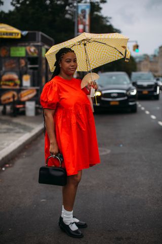 woman wears ballet flats and a red dress