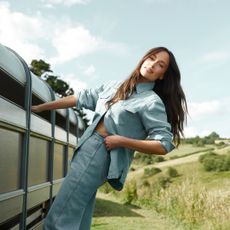 Kacey Musgraves leaning off a horse trailer in the Cotswolds in England