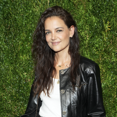 Katie Holmes wears a black leather jacket and a white t-shirt